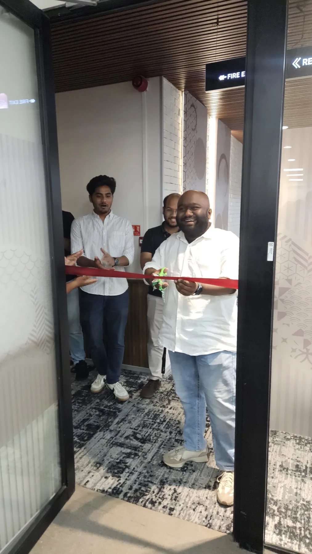 Saiyed Abdal cutting the ribbon at an office opening